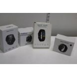 Four boxed smart watches