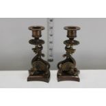A pair of bronze candlesticks with dragon decoration