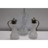 A pair of cut glass & plated claret jugs & one other