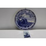 A large Delft ware charger & wall tile