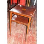 An Edwardian inlaid mahogany two tier square occasional table with chequer inlay upon tapering