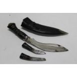 A small Kukri style knife & two smaller ones in scabbard