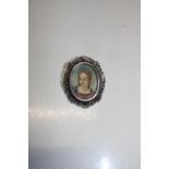 A vintage silver portrait brooch