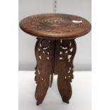 A Carved folding Indian tea table with Brass inlay to the top