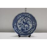 A Blue and White Plate with peacock design. Signed at the back