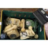 A box of vintage telephones