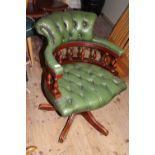 A quality Captains chair with green leather upholstery