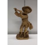 A tall Carved Wooden Boy Playing Flute