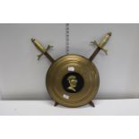 A novelty brass shield and sword wall hanger