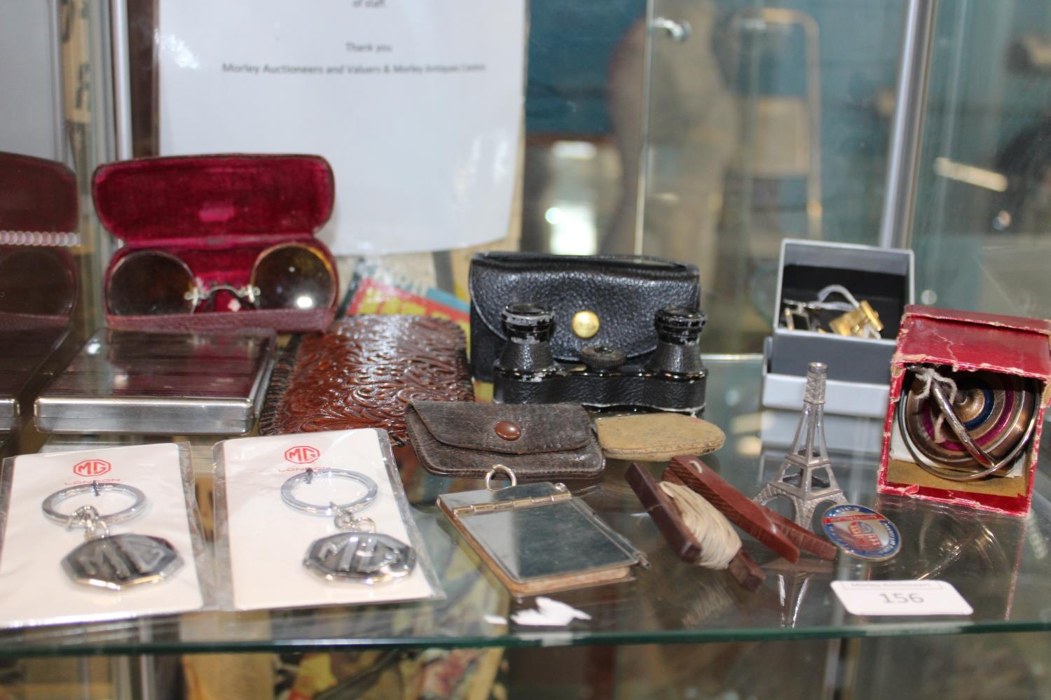 A good shelf of misc items including a sovereign purse, aide memoire etc