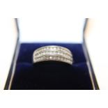 A 9ct white gold ring with channel set diamonds