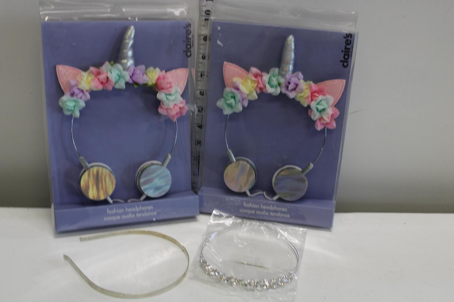 Two Claire's fashion headphone sets