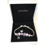 A boxed Pandora bracelet with charms