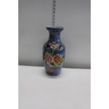 A ceramic vase with lustre floral decoration