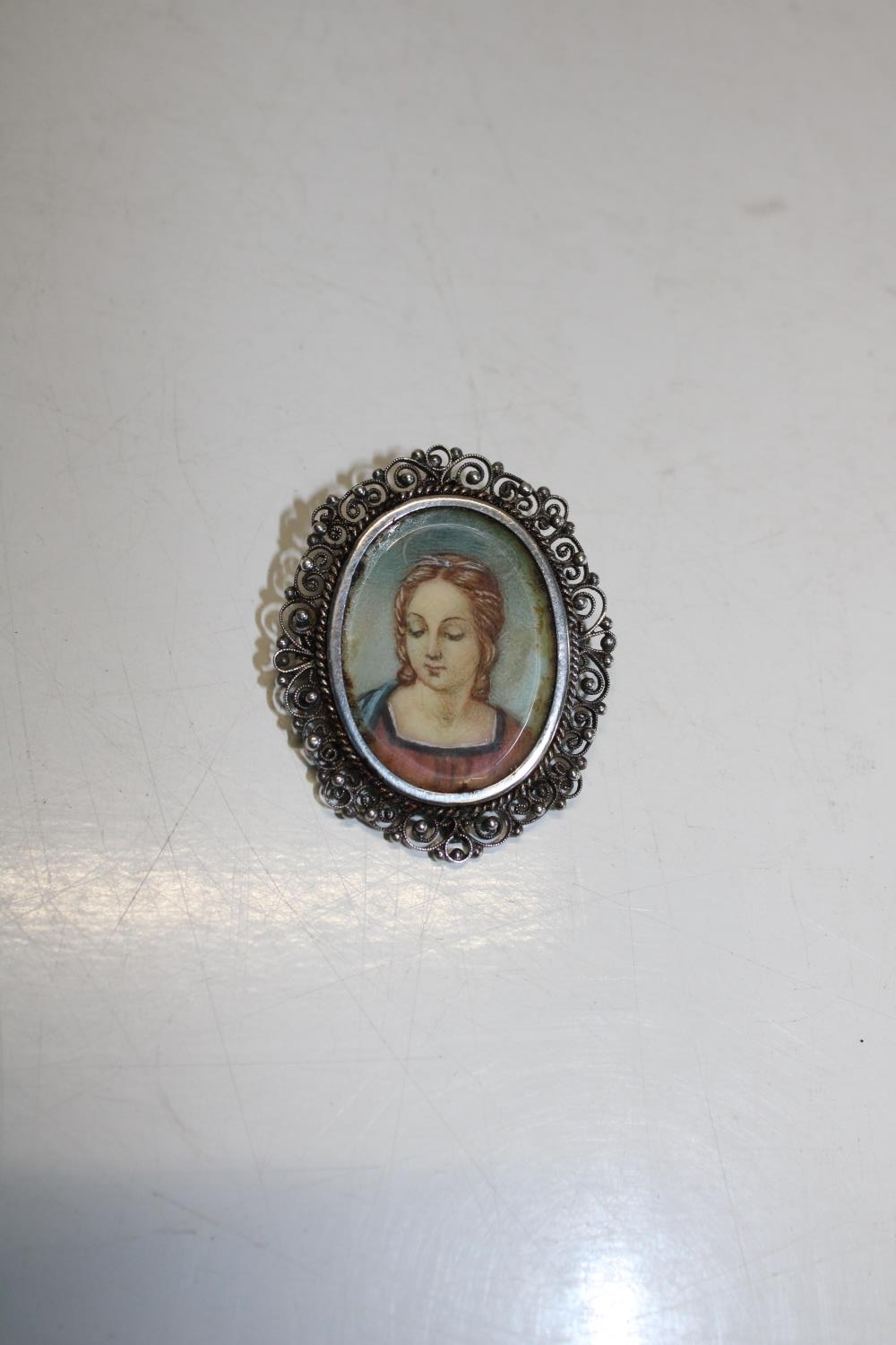 A vintage silver portrait brooch