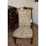 A Victorian nursing chair in mahogany on metal castors collection only
