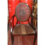 A well made Edwardian open arm chair with rattan seat & back with tapered legs. (Seat needs some