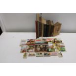A job lot of vintage books and annuals with collectors cards etc