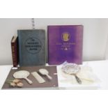 A boxed silver plated dressing table set and vintage books