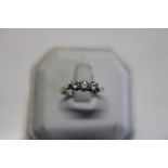 A 9ct gold spinel trilogy ring set in silver A/F