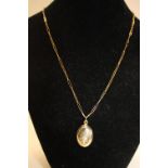 A 14ct gold locket on a 9ct gold paper chain