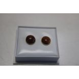 A pair of 9ct gold & gold stone stud earrings