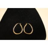 A pair of large 9ct gold hoop earrings