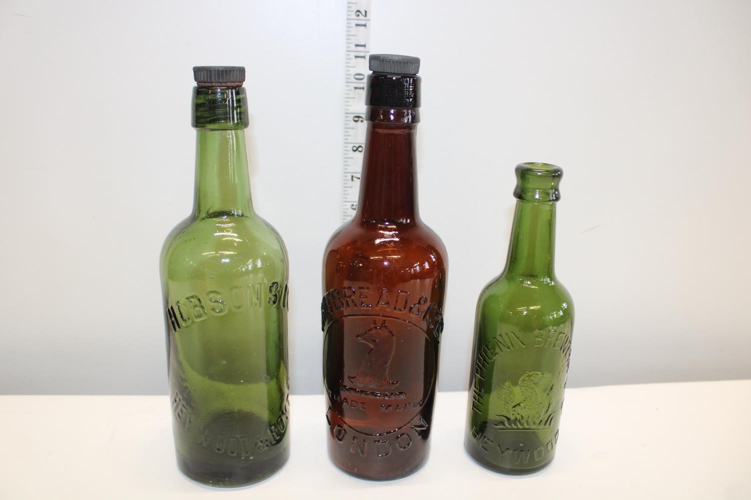 Three vintage advertising bottles
