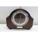 A antique wood cased mantle clock