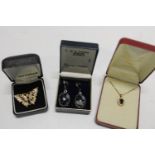 Three boxed pieces of costume jewellery