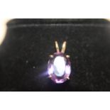 A 14ct gold & purple stone pendant. 4.94 grams