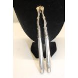 A pair of silver handled nut crackers