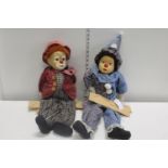 Two vintage clown dolls on swings