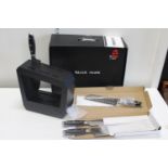 A boxed Black Hawk kitchen knives set. Two knives missing. Sold as seen