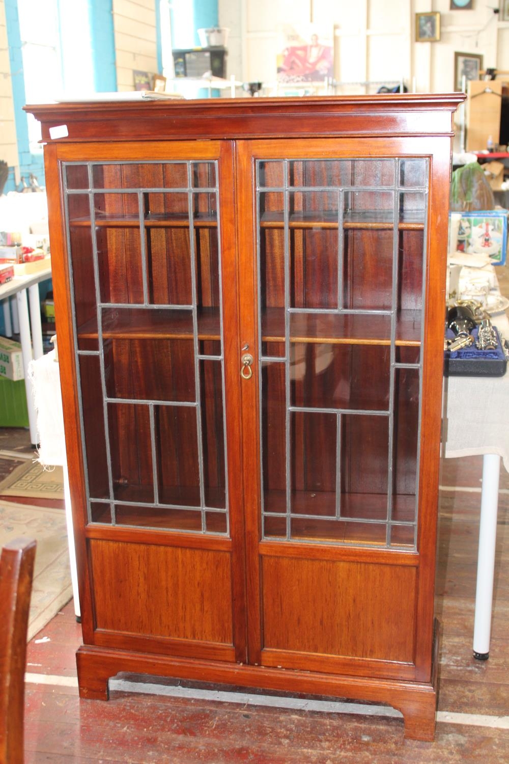 A vintage mahogany display cabinet with lead glazed panels. Postage unavailable. h137cm x