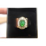 A 18ct gold ring with green central stone. 8.73 grams (for scrap or repair)