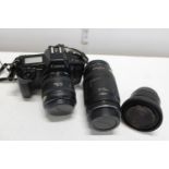 A Canon EOS 650 camera with a Canon EF 70-210mm 1:4 lens & two other