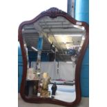 A large mahogany bevelled edged glass mirror. Postage unavailable 78cm high