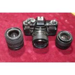 A Praktica BMS electronic camera body & two Carl Zeiss lenses & one Sigma lens