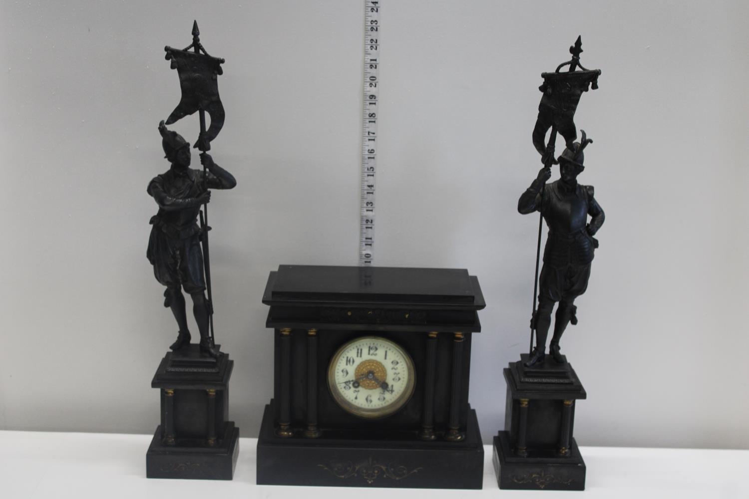 A quality French late Victorian period mantle clock with a pair of slate mounted spelter garnitures.