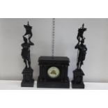 A quality French late Victorian period mantle clock with a pair of slate mounted spelter garnitures.