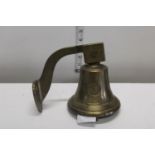 A wall mounted brass bell