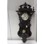 A vintage mahogany cased wall clock (has some damage) postage unavailable