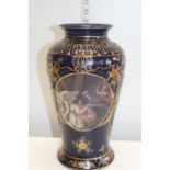 A hand decorated vase with transfer print