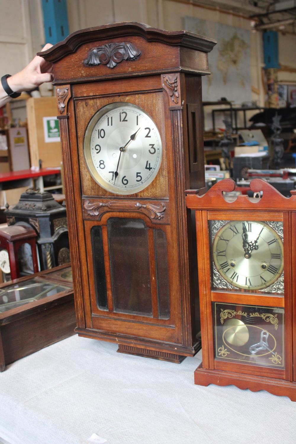 Two vintage wooden cased wall clocks, larger one converted for battery use a/f postage unavailble