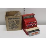 A vintage boxed child's cash register with money