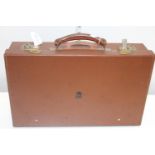 A government issue leather attache case with royal cipher to one side