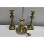 A pair of brass candlesticks & chamber stick