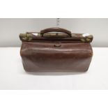 A vintage leather Gladstone bag