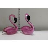 A pair of art glass flamingos